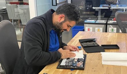 IT technician fixing a laptop